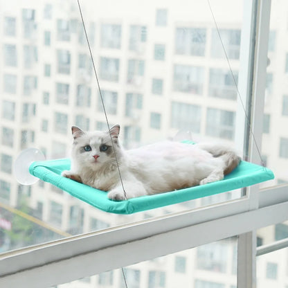 Angled three-quarter view of the Suction Cup Wall-Mounted Window Hammock mounted on a window