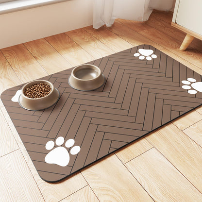 Coffee colour herringbone pet feeding mat with paw-print corners holding a food bowl and water bowl