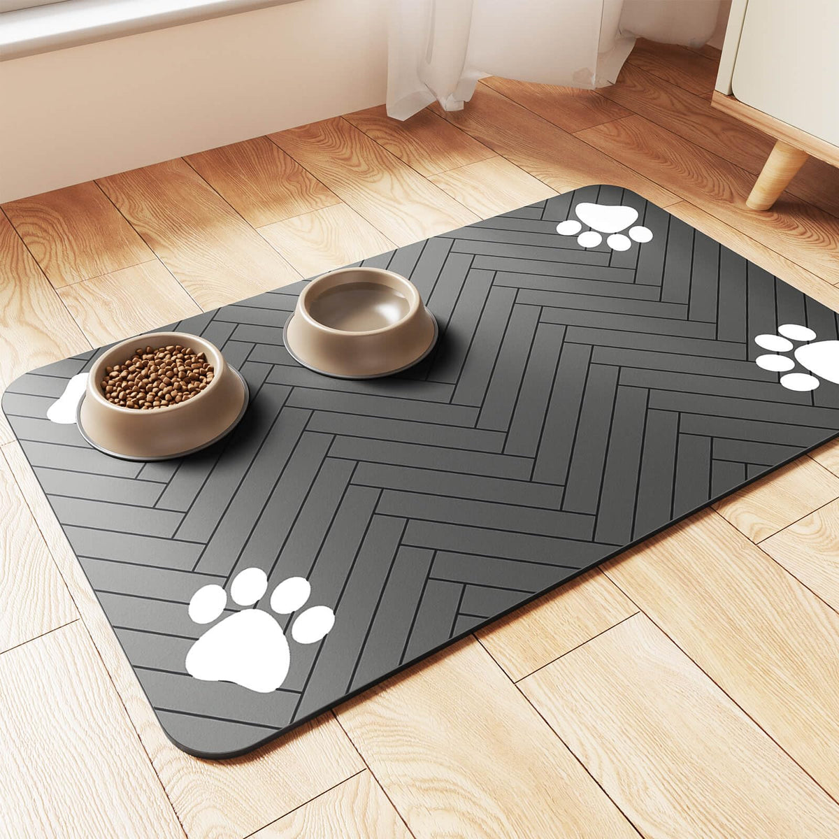 Dark gray herringbone pet feeding mat with paw-print corners holding a food bowl and water bowl